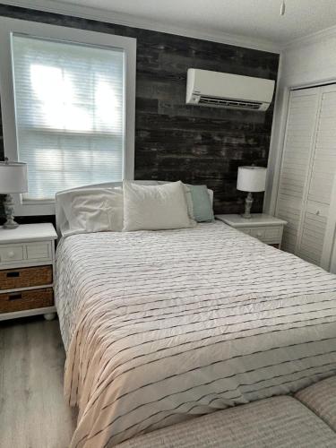 a bedroom with a large bed and two night stands at Chucks Cottage in Cape Charles in Cape Charles