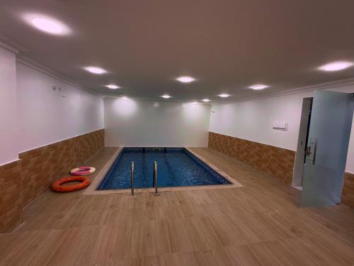 an indoor swimming pool with an orangequal at Labella Chalet in Barka