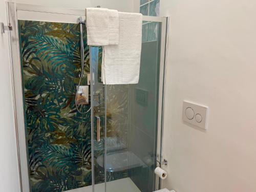 a bathroom with a shower with a glass shower stall at Taormina Naxos Home 2 in Giardini Naxos