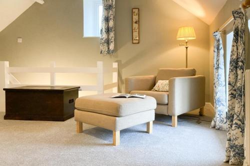 a living room with a chair and a ottoman at 2 Bed in Chideock oc-c36616 in Chideock