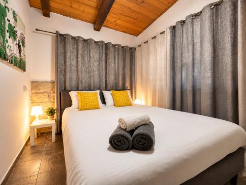 a bedroom with a large bed with towels on it at המקום של ברקו in Me‘ona