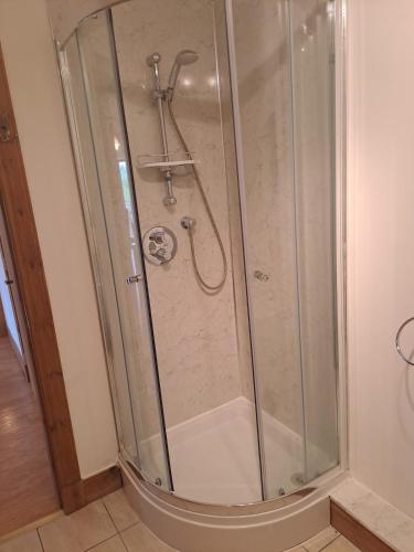 a shower with a glass enclosure in a bathroom at Glen Lyon in Inverurie