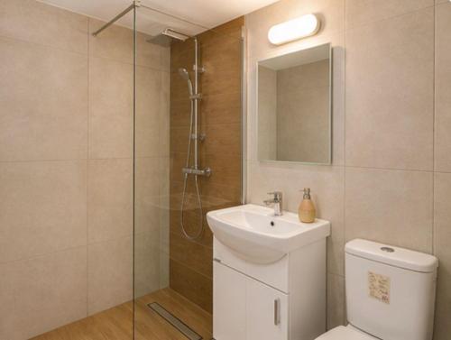a bathroom with a toilet and a sink and a shower at Luxury hideaway in Larnaca