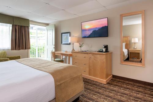 a hotel room with a bed and a desk at Bar Harbor Villager Motel - Downtown in Bar Harbor