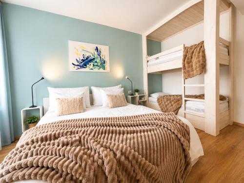 a bedroom with a bed and a bunk bed at Apartment Schober - Rezidence K Lanovce in Jáchymov