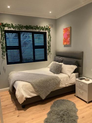 a bedroom with a large bed and a window at Almond Place in Tokai