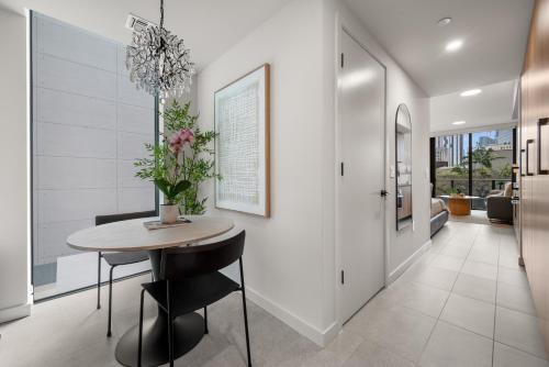 a dining room with a table and a vase of flowers at 501 First Residences by Palermo Home Miami in Miami