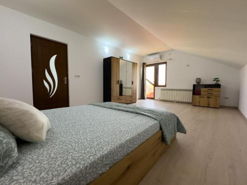 a bedroom with a large bed and a wooden floor at Casa Maia Corbu in Corbu