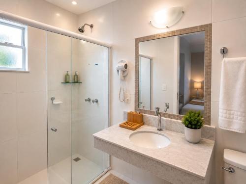 a bathroom with a sink and a shower at Flats Morro de São Paulo in Morro de São Paulo