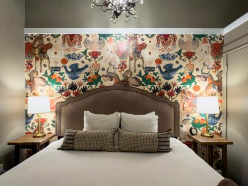 a bedroom with a bed with a floral wallpaper at 3rd Street Flats in McMinnville
