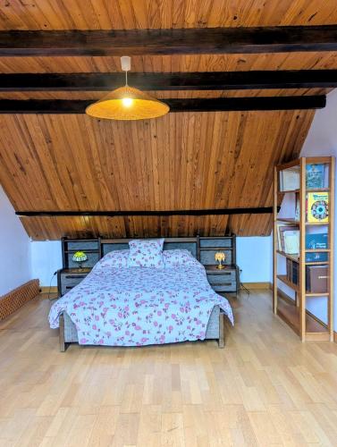 a bedroom with a bed and a wooden ceiling at Escapade bucolique calme et nature in Saint-Léger-aux-Bois