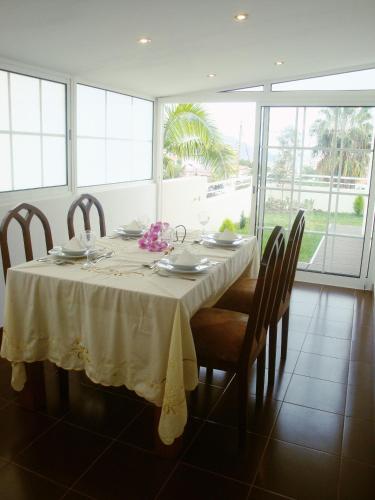 a dining room table with a white table cloth and chairs at Mericia's Gorgeous View in Funchal