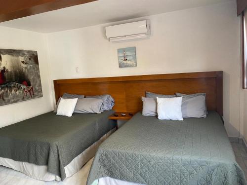 two beds in a hotel room with two beds at Galeria Elementos, Tierra in Campeche