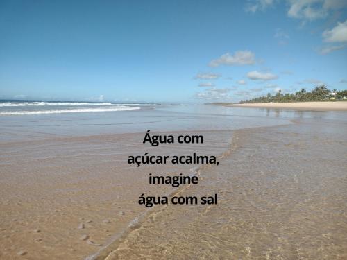 an image of a beach with the words agua com afteratlantic imagine ep at Refúgio Guarajuba, 50m da Praia, Piscina, Recarga EV, área gourmet, churrasqueira in Camaçari