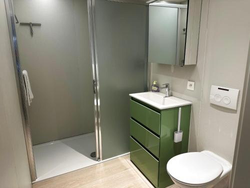 a bathroom with a shower and a toilet and a sink at Art Donna met zeezicht in Middelkerke