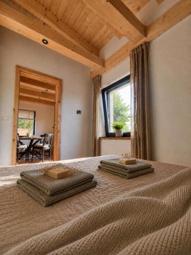 a bedroom with a bed with two towels on it at Das Seehaus Buckow in Buckow