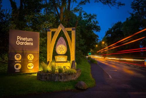 a sign for a pittin carbons on the side of a road at Pinetum Garden Cottages in St Austell