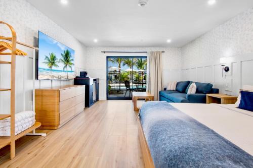 a hotel room with a bed and a couch at Tropic Isle At Anna Maria Island Inn in Bradenton Beach