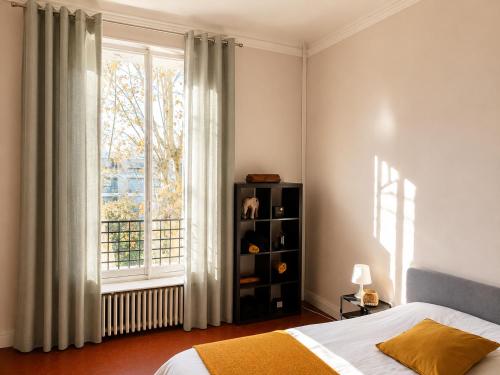 a bedroom with a bed and a large window at Chambre dans villa privée, charme et confort proche Vélodrome & plages - Parking privé in Marseille