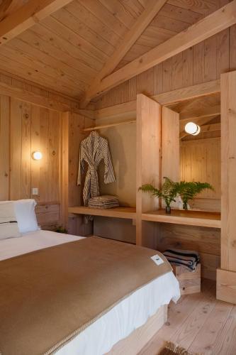 a bedroom with a bed in a wooden room at Yogi's Cabin in Battle