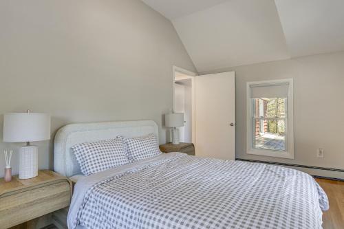 a white bedroom with a bed and a window at Tranquil Catskills Home w/ Creek & Fire Pits in Parksville