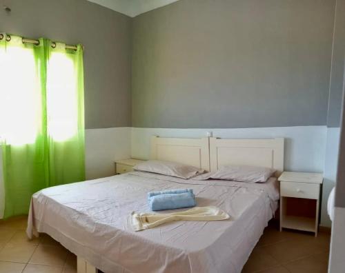 a bedroom with a bed with a towel on it at Ponta Preta Village 9 in Vila do Porto