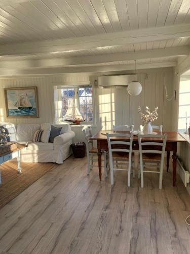 a living room with a table and a couch at Pålberget in Råkvåg