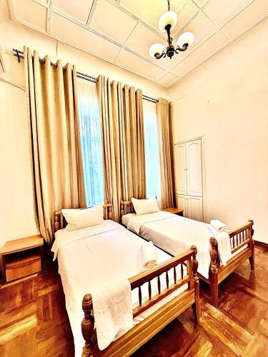 a bedroom with two beds and a window at Officers Boutique Hotel in Samarkand