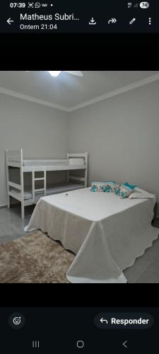 a rendering of a bedroom with a bed and a table at Recanto Rafaela 2 in Olímpia