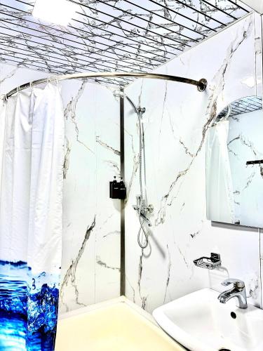 a bathroom with a shower and a sink at Officers Boutique Hotel in Samarkand