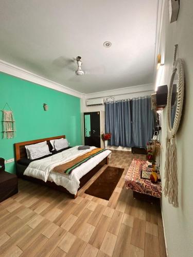 a bedroom with a large bed with blue walls at Varāya 1RK Studio in Vrindāvan