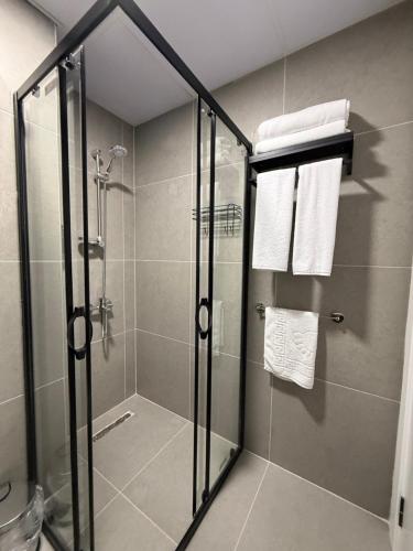 a shower with a glass door in a bathroom at Twelve Diamond Hotel in Istanbul