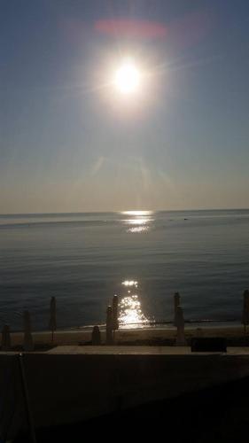 a view of the ocean with the sun rising over the water at Nepheli in Paralia Katerinis