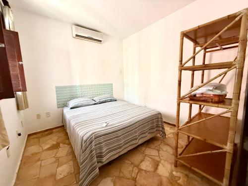 a bedroom with a bunk bed and a ladder at Triplex em Maracajaú a beira-mar in Maxaranguape