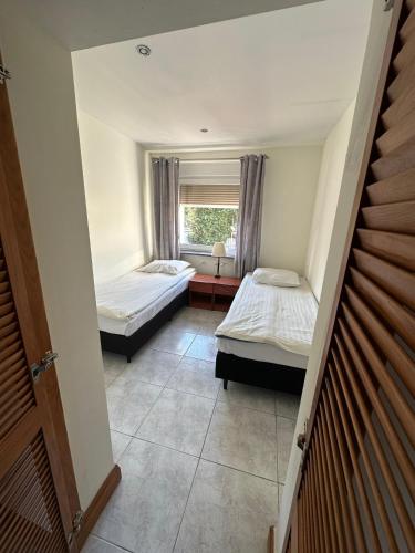 a room with two beds and a window at Willa Rudno Nad Jeziorem in Rudno