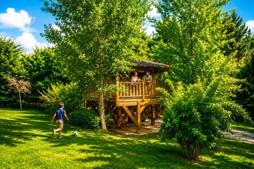 a group of people in a tree house at Les Chalets du Brusquand in Marquay