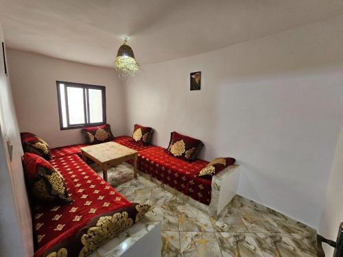 a room with two beds and a table in it at ADAGHAS studio 1,3 in Agadir