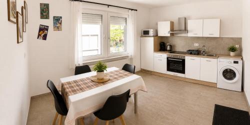 a kitchen with a table and chairs and a kitchen with a sink at Ferienwohnung Ernzerhof in Idar-Oberstein