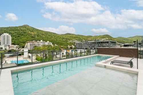 a swimming pool on the roof of a building at Modern Studio | Pool | Gym #SG10 in Florianópolis