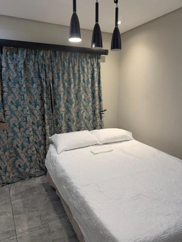 a bedroom with a large bed with a curtain at Be my guest in Roodepoort
