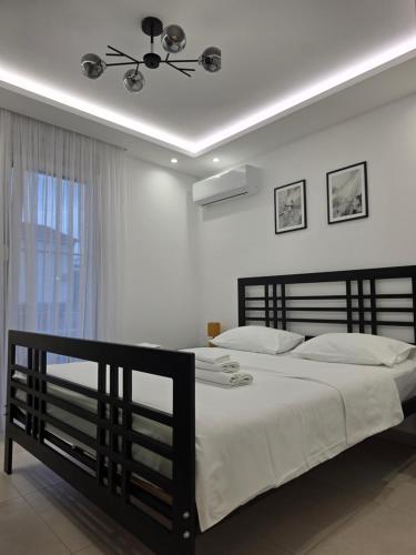a bedroom with a large bed and a ceiling fan at Sunset Apartment in Kotor