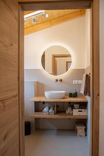 a bathroom with a sink and a mirror at Rotbauernhof - Chalet - in Gutach