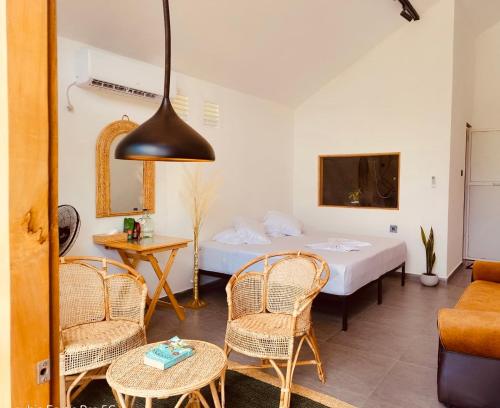 a room with a bed and chairs and a table at Galactic Glow Villa & Resort in Deniyaya