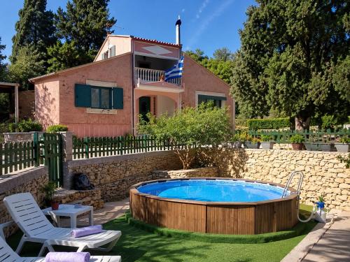 a house with a swimming pool in the yard at Anna's Country Villa Privé in Karés