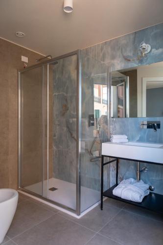 a bathroom with a shower and a sink and a toilet at Acciuga Hotel in Laigueglia