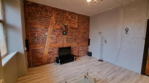 a living room with a brick wall and a fireplace at Helme mõis in Helme
