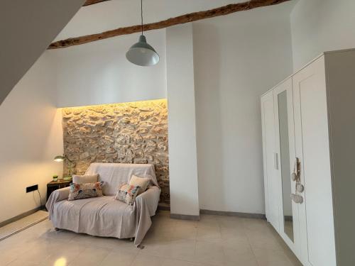 a bedroom with a bed with a painting on the wall at Casa Inés in Xerta