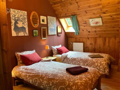 a bedroom with two beds and a couch in it at The Village in Anzat-le-Luguet