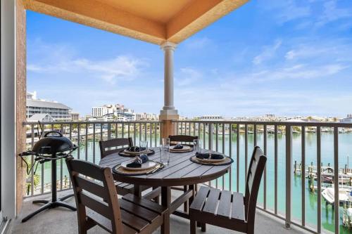 a table on a balcony with a view of the water at Harborview Oasis in Clearwater Beach in Clearwater Beach