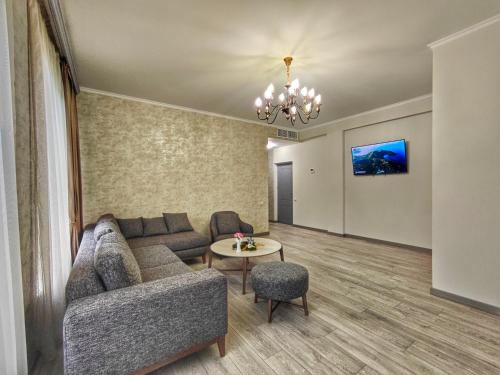 a living room with a couch and a table at Hotel Ijevan in Ijevan